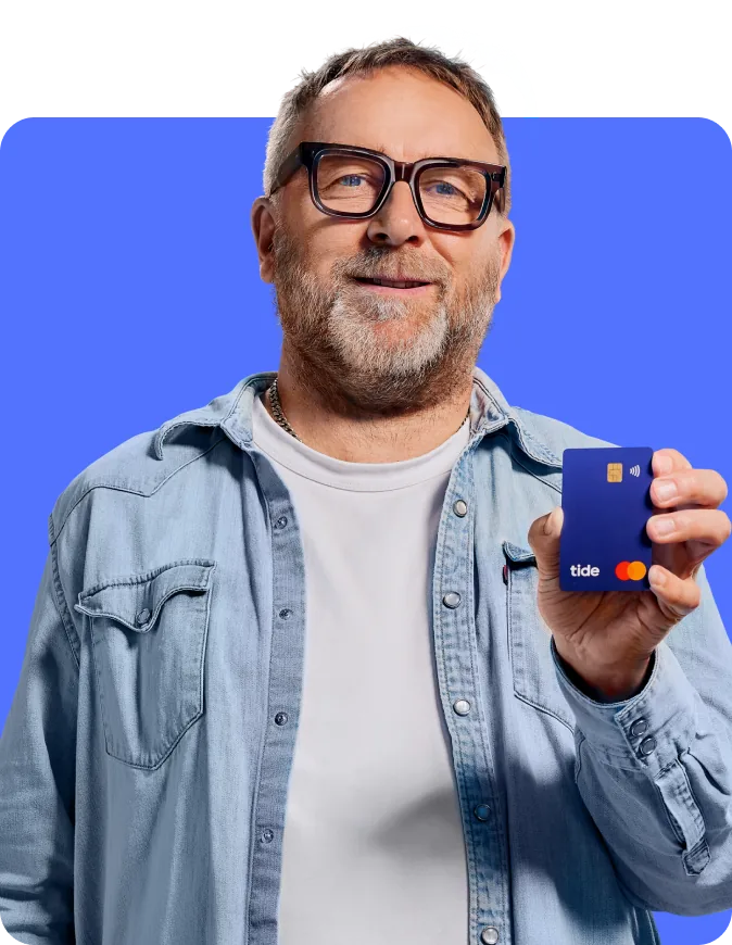 Tide business customer holding a Tide debit card